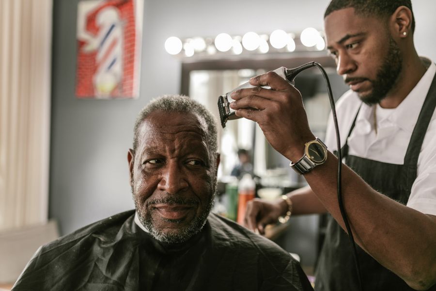 Barber using clippers on a client