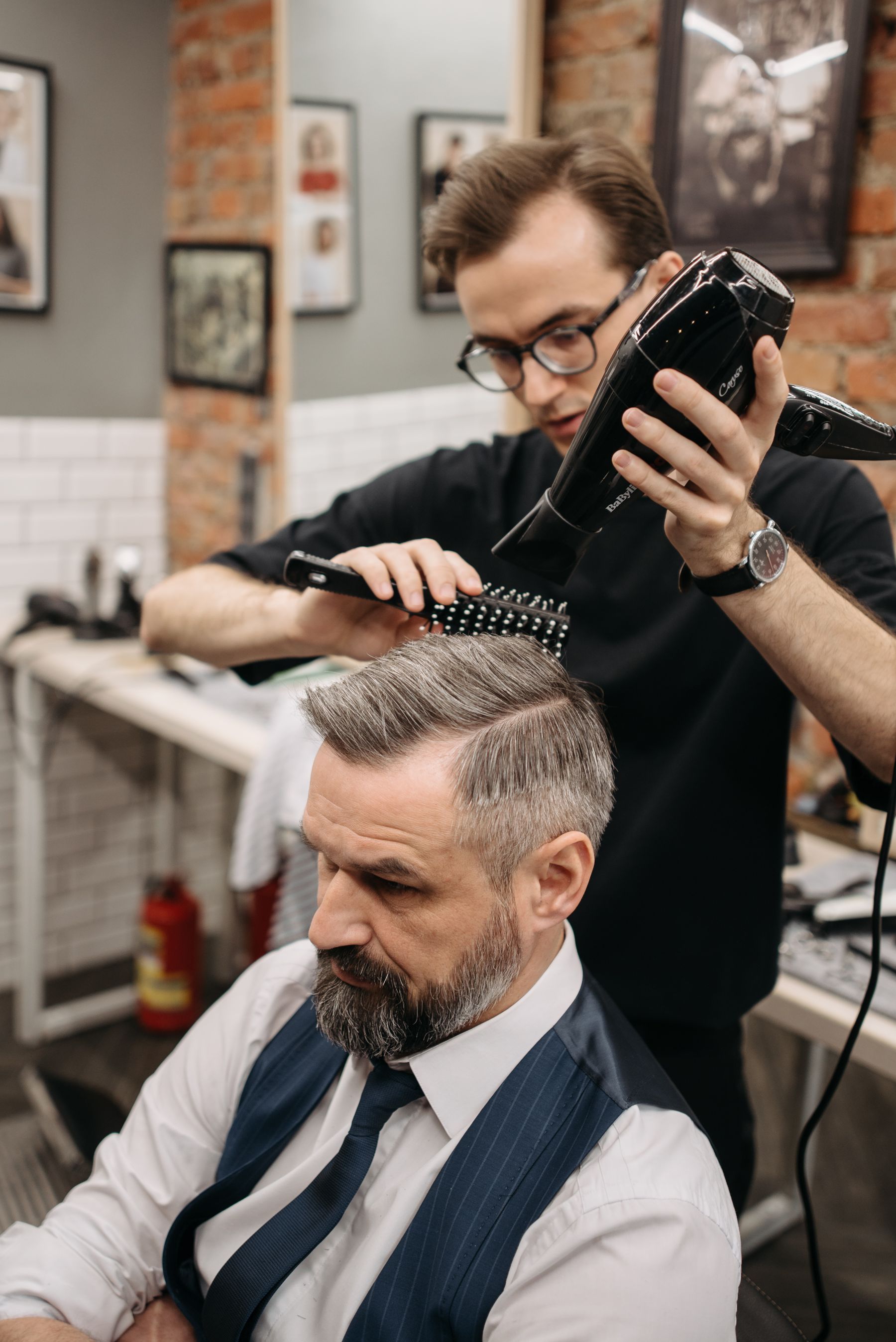 Barber styling a client's hair